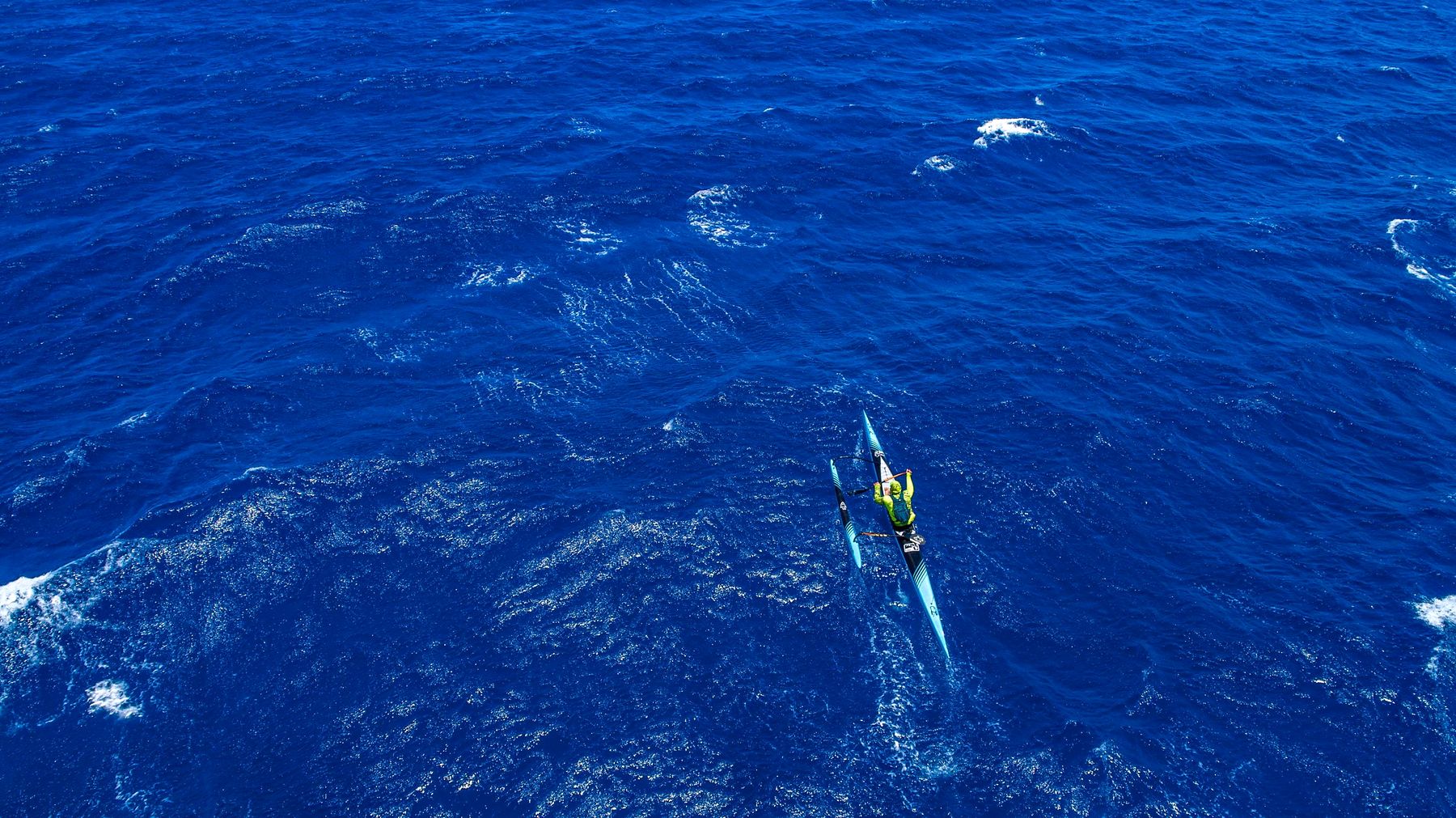 Aerial view of a paddler crossing the Pailolo Channel