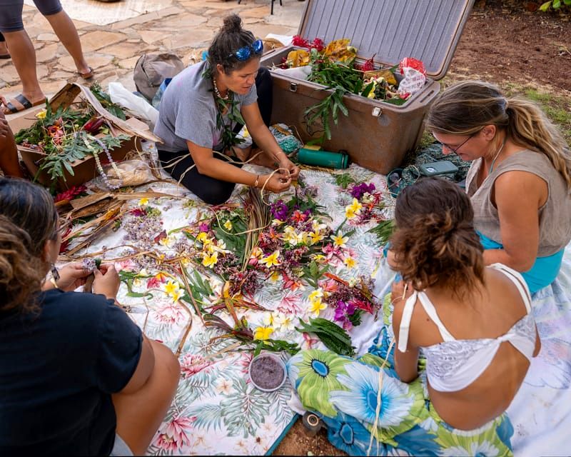 Families making lei together at a cultural workshop