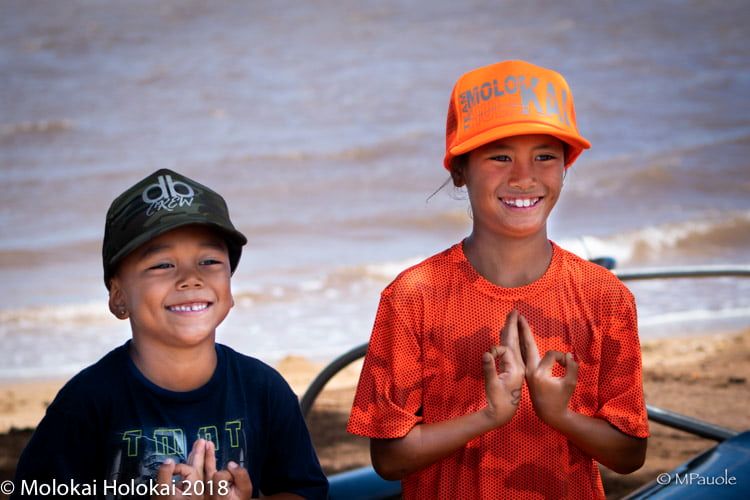 Two young boys grin at the camera